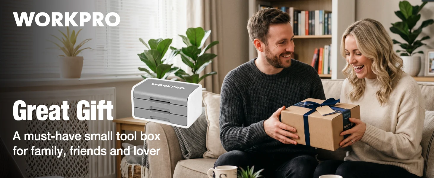 Couple on a living room couch opening a wrapped gift box, with WORKPRO tool box on a side table