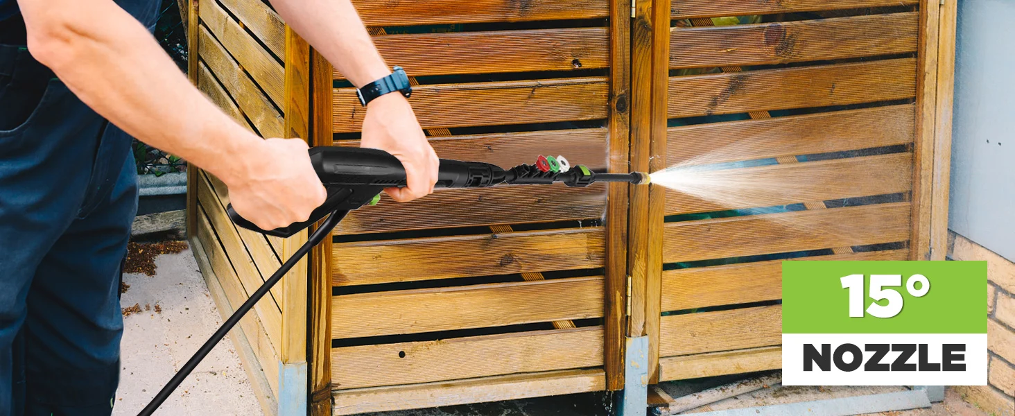 Person pressure washing a wooden gate with a black nozzle, showing innovation and quality in outdoor cleaning