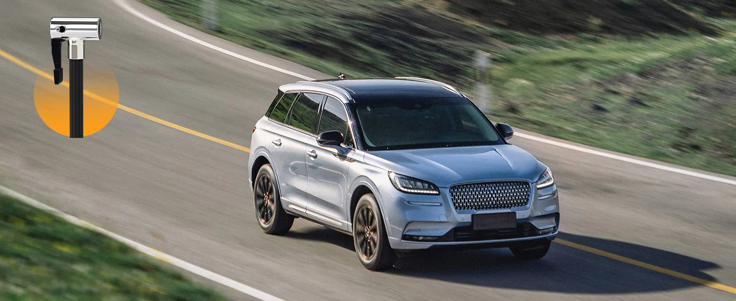 Blue and silver station wagon driving on a highway, with innovation and quality shown in motion and road lighting