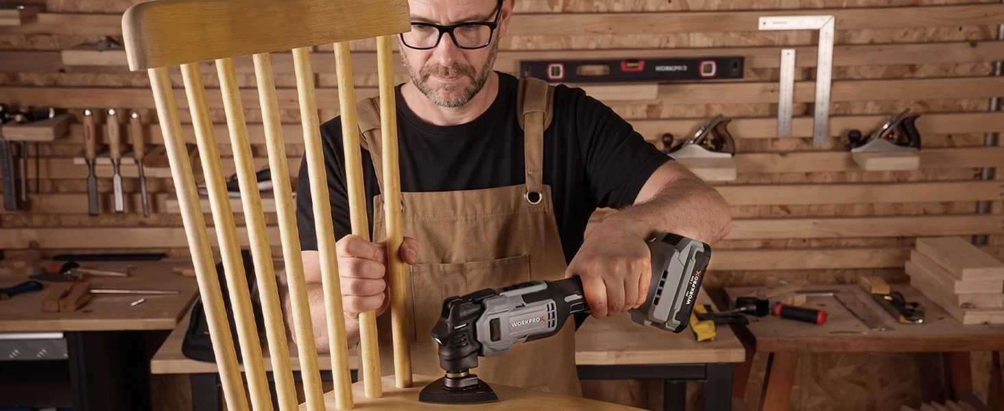 Woodworker using a cordless power tool in a workshop, innovation and quality shown through careful repair work