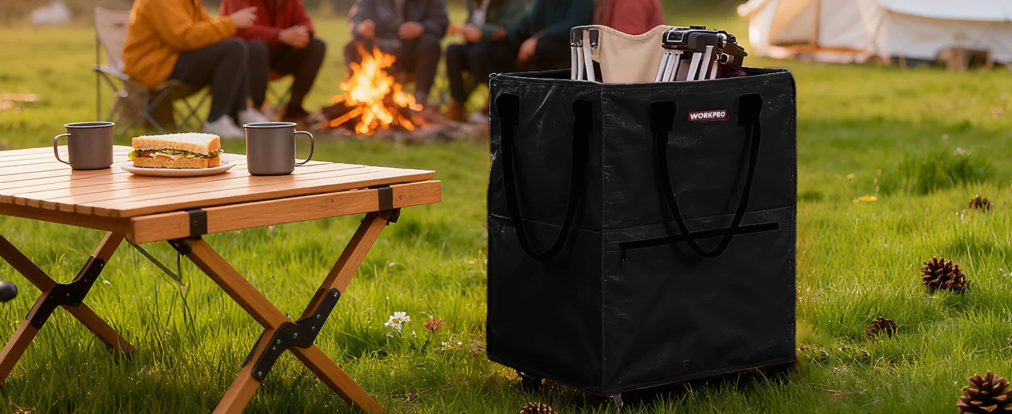 Outdoor camping setup with a black work bag near a wooden table, mugs, and a campfire, innovation and quality