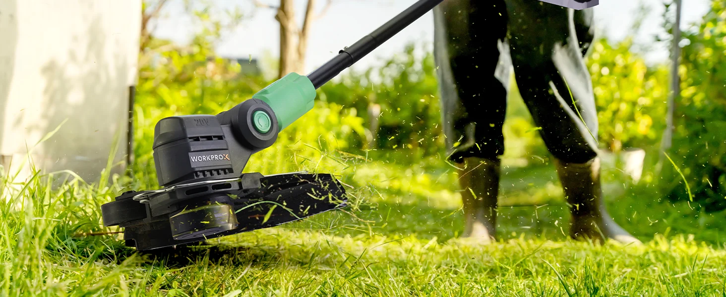 Innovation quality high-quality durable lawn trimmer with green handle cutting grass, sparks flying outdoors