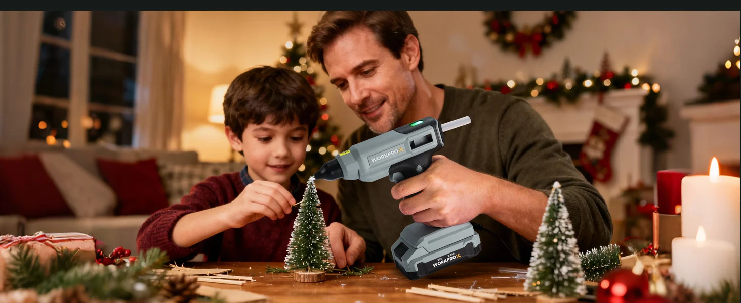 Father and child use a cordless drill to assemble a small Christmas tree on a table during a festive holiday evening