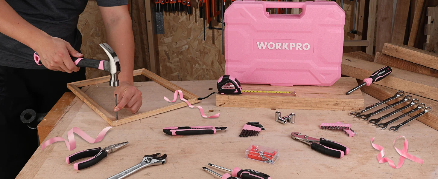 Person using a hammer on a wooden board with tools on a workbench, with Workpro case and pink ribbon