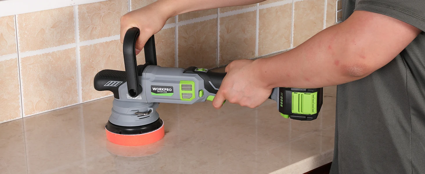 Hand using a cordless angle grinder on a tiled wall, with innovation and quality shown on the tool display