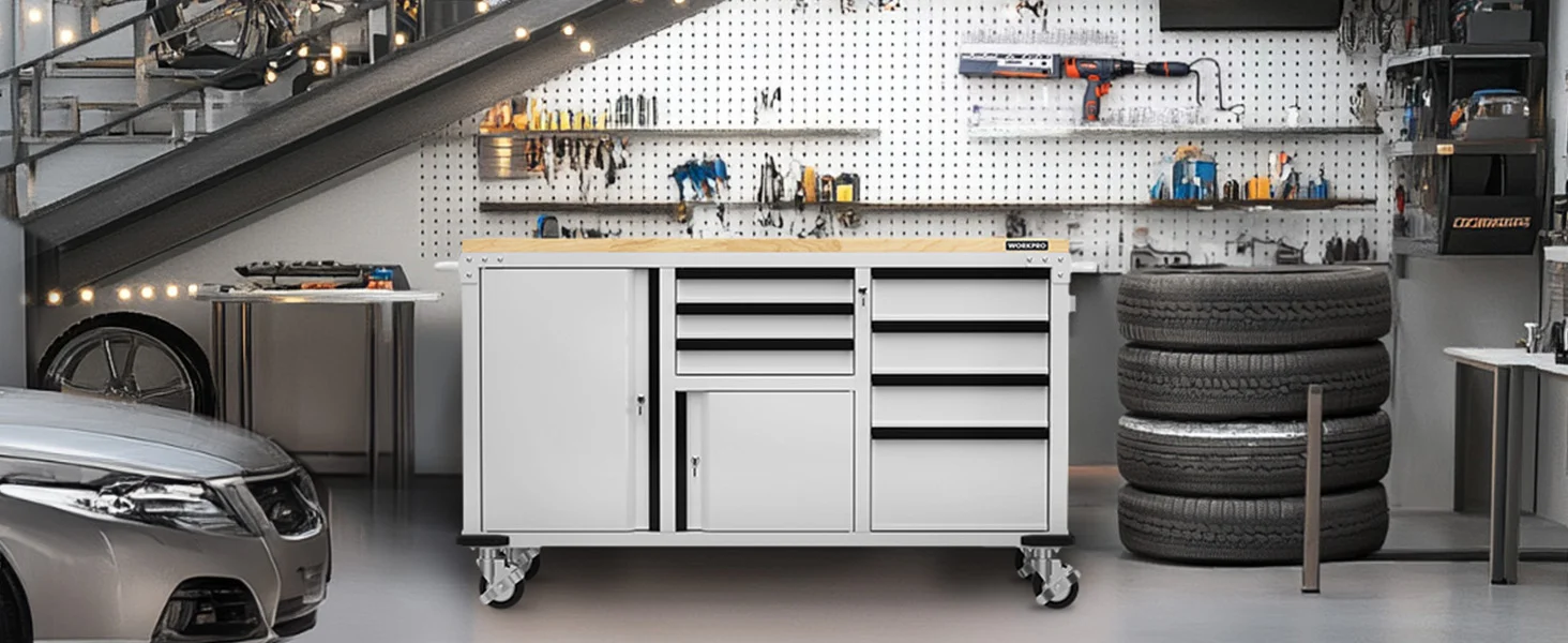 Tool cabinet on rolling casters in a garage workshop, with tires stacked and power tools on pegboard wall