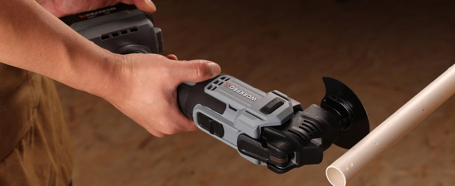 Angle grinder tool in a hand cutting a metal pipe, showing innovation and secure grip on the handle
