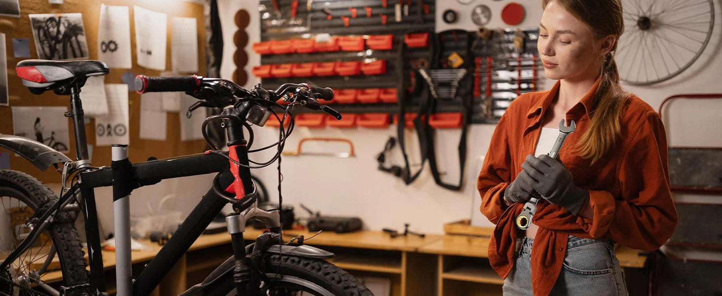Mechanic in a bike workshop adjusting a handlebar, with innovation and quality tools in the background