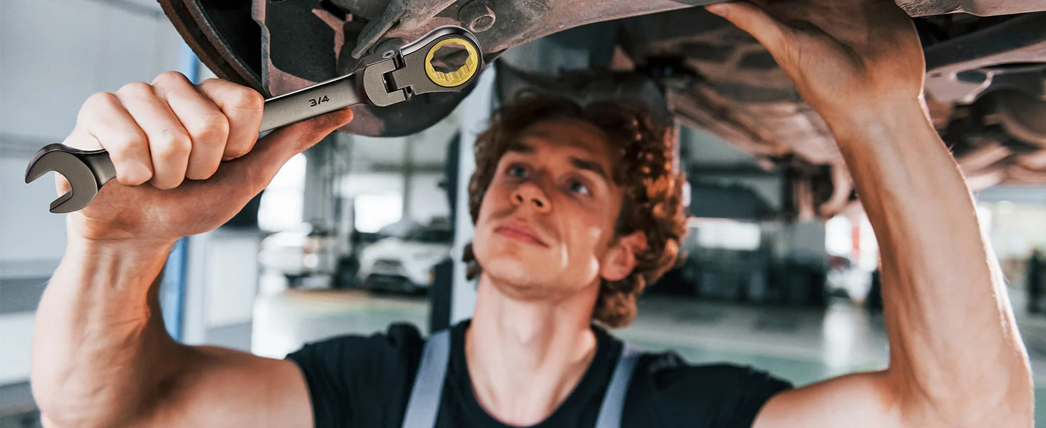 Mechanic holding a wrench and lifting a metal engine part, showing innovation and quality in a workshop