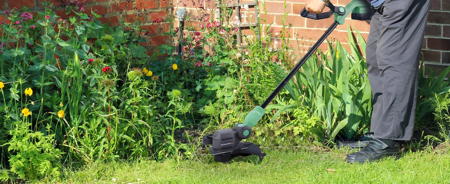 A person trims a backyard garden with a cordless weed trimmer, showing innovation and quality in use