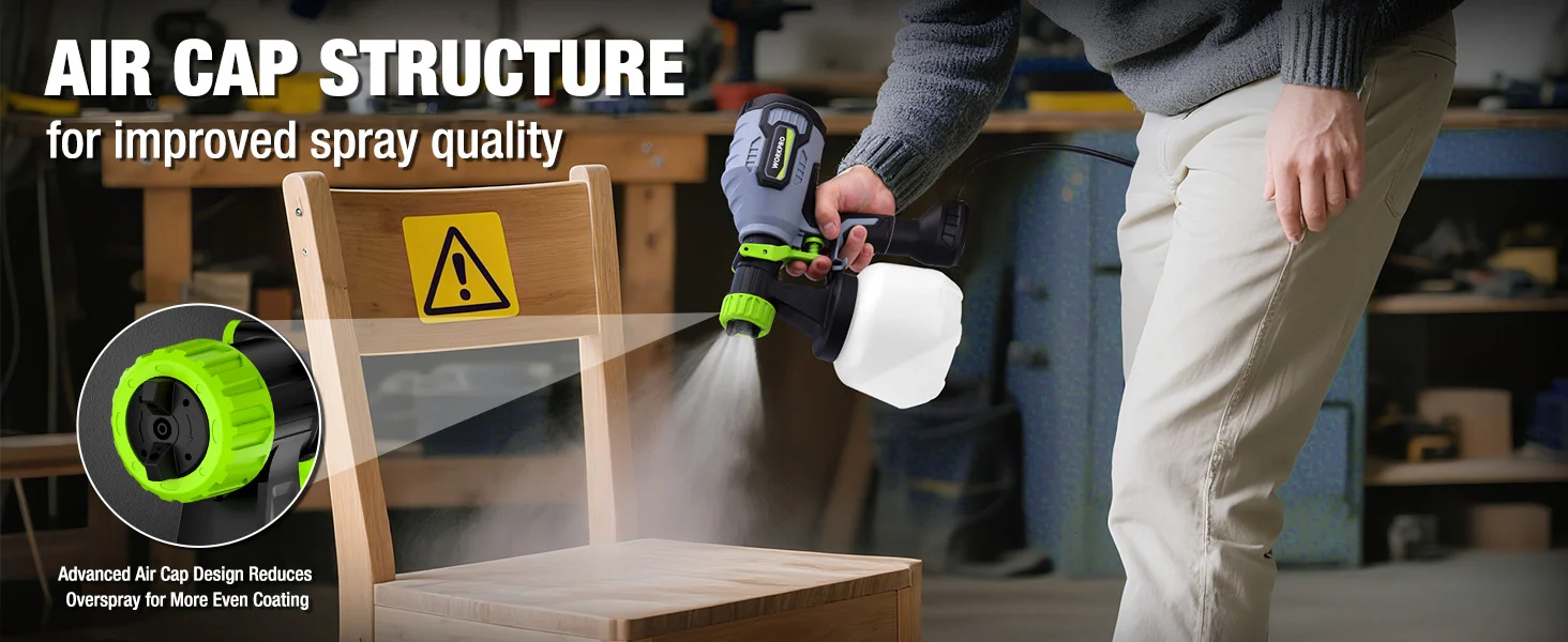 Person spraying a wooden cabinet with a handheld air cap nozzle in a workshop, showing innovation and quality
