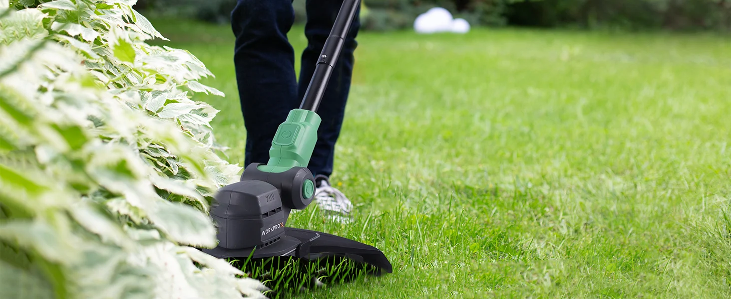 Cordless lawn trimmer cutting grass in a green yard, with innovation and quality in the tool head
