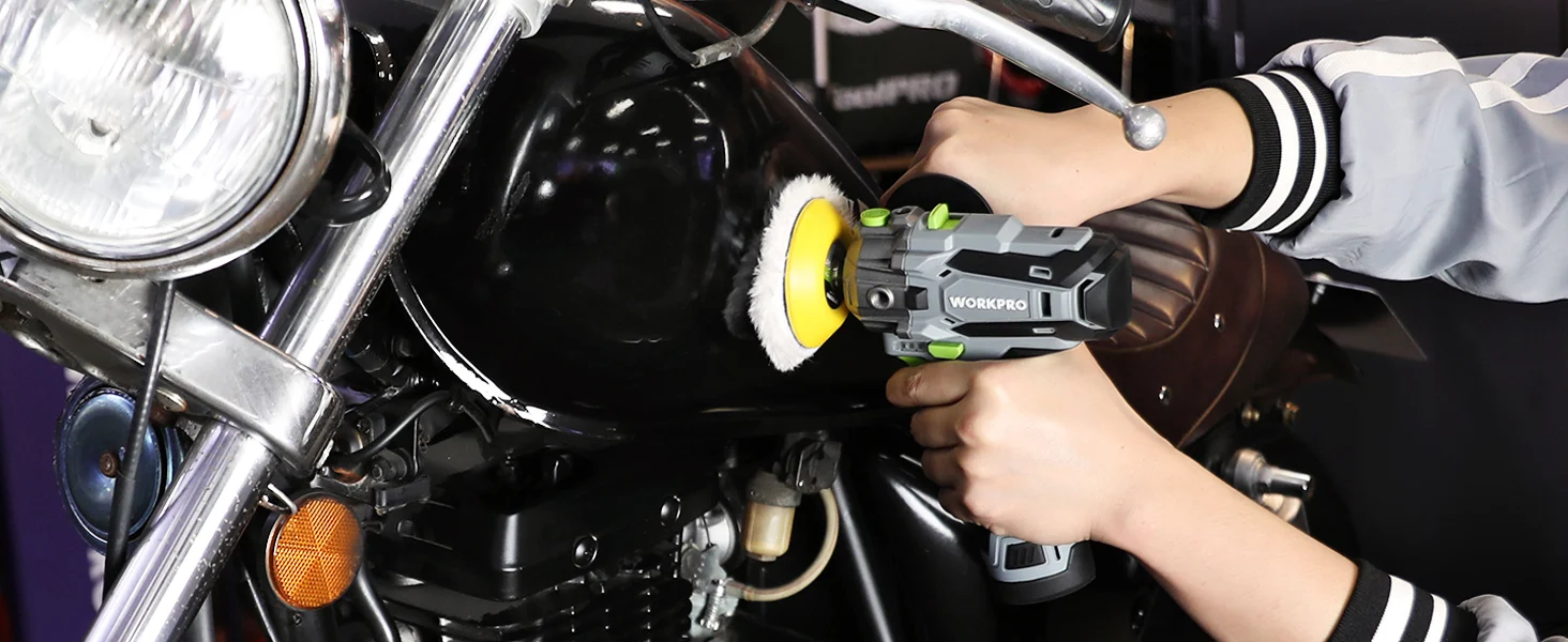Hand holding a power tool with a yellow polishing pad on a motorcycle engine, showing innovation and quality