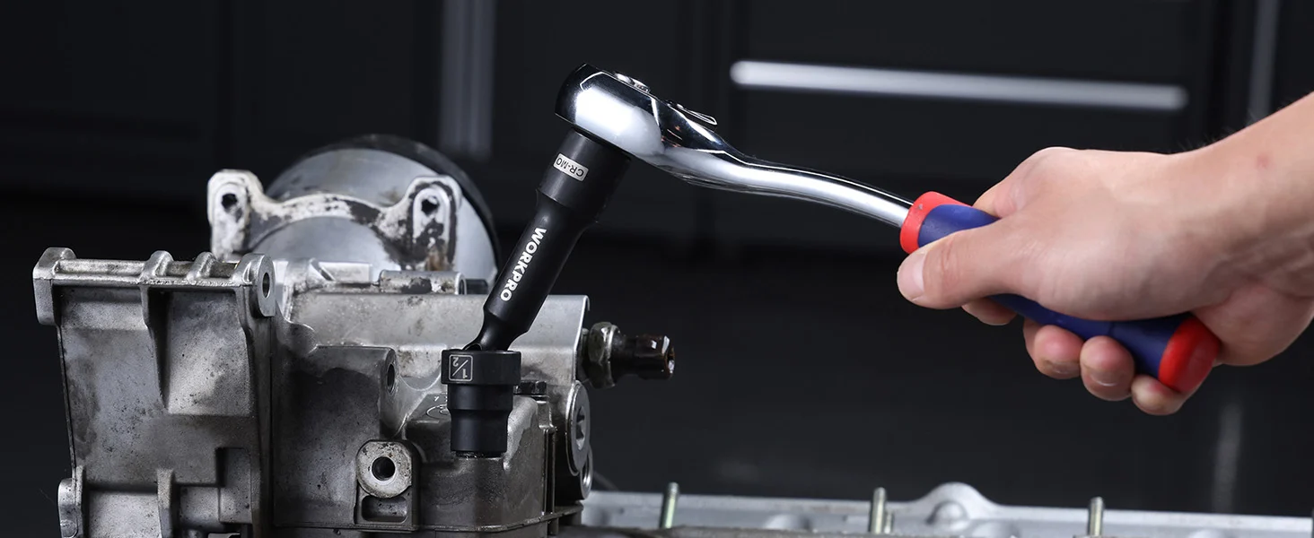 Mechanic hand using a ratchet wrench on a metal engine block, showing innovation and quality in repair work
