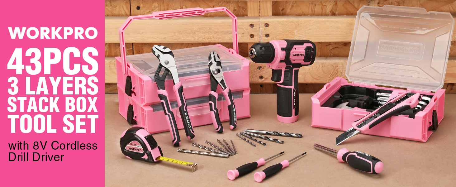 Pink and black cordless drill driver tool set with stacked case, bits, and wrenches on a wooden workbench