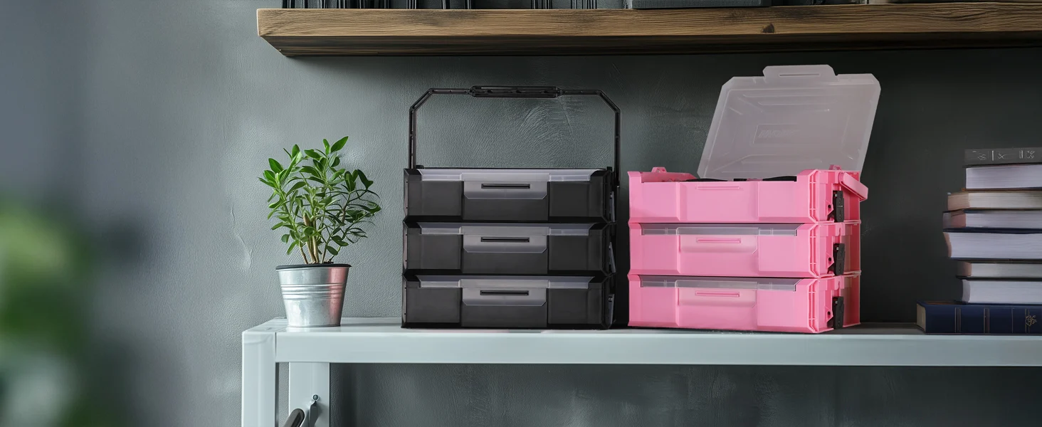 Stacked plastic storage bins in black and pink on a shelf with a small potted plant, innovation and quality