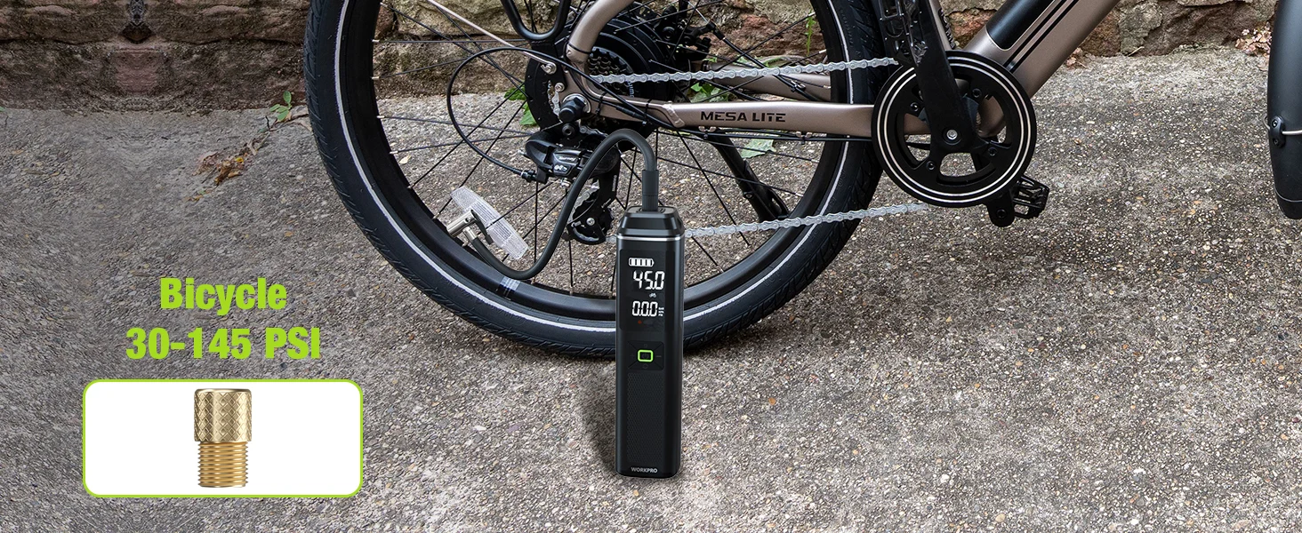 Bicycle tire pressure gauge shows 450 PSI beside a bicycle wheel on pavement with a valve adapter