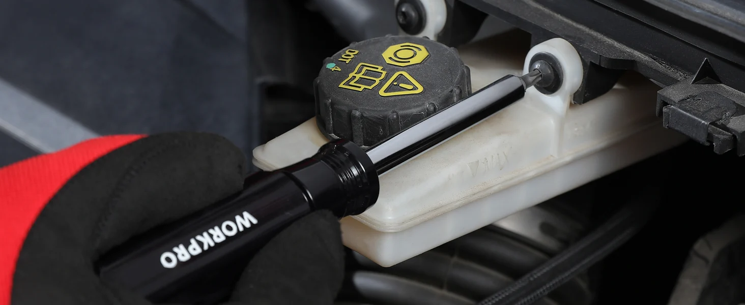 Automotive tool handle with WORKPRO text and a yellow cap on a brake fluid reservoir, showing innovation and quality