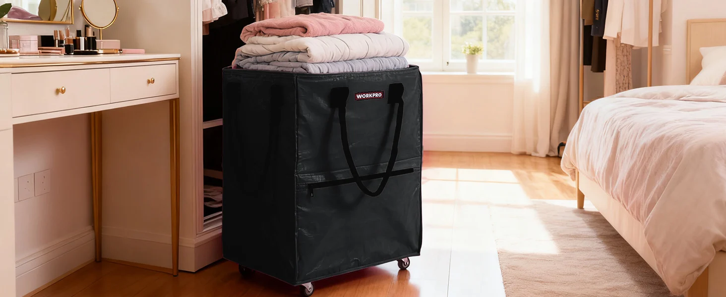 Black storage bin with handle on wheels in a bright bedroom, stacked folded linens inside for convenient organization