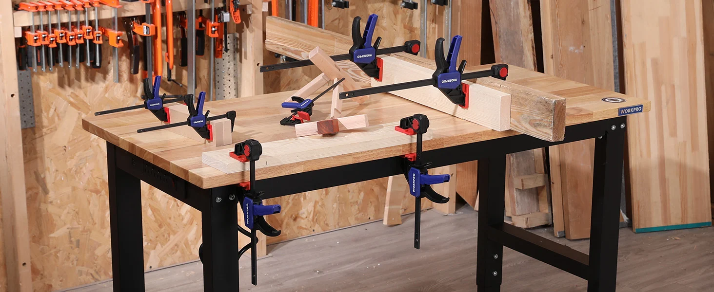 Woodworking workbench with clamps and orange tool holders, showing innovation and quality in a workshop