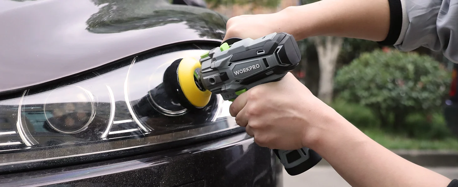 Hand using a cordless power tool to polish a car headlight lens, showing innovation and high-quality finish