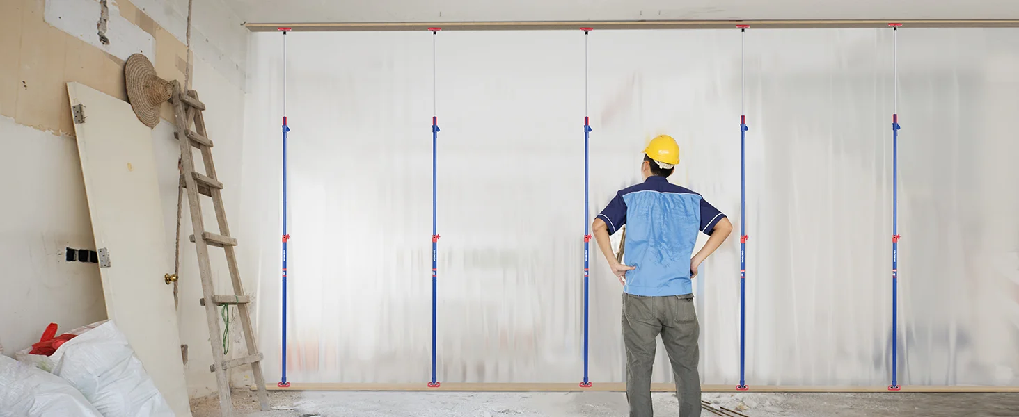 Construction worker in a yellow hard hat standing beside plastic sheeting, with innovation and quality worksite setup