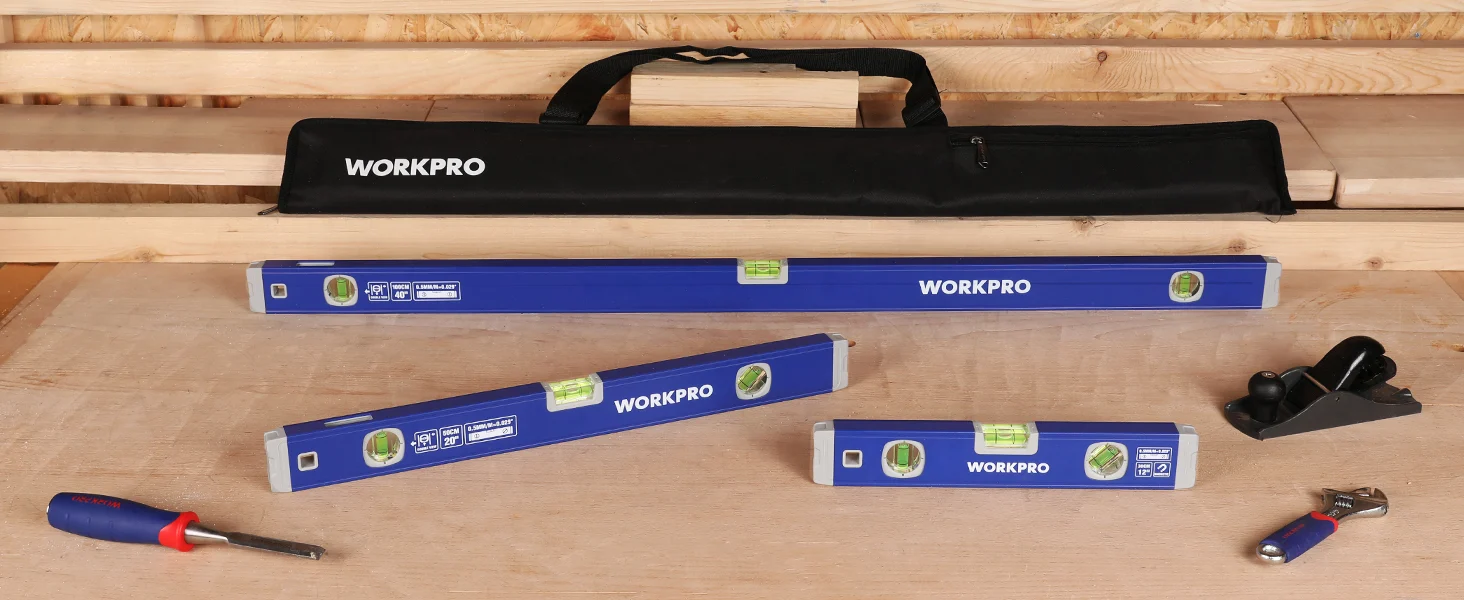 Workpro spirit level set with innovation and quality markings, plus a durable tape measure and tools on wood