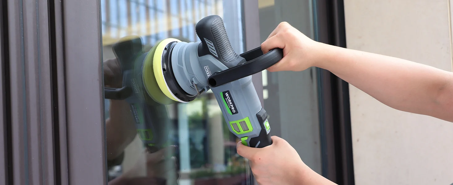 Handheld cordless angle grinder at a window frame, with innovation and quality in the durable tool body