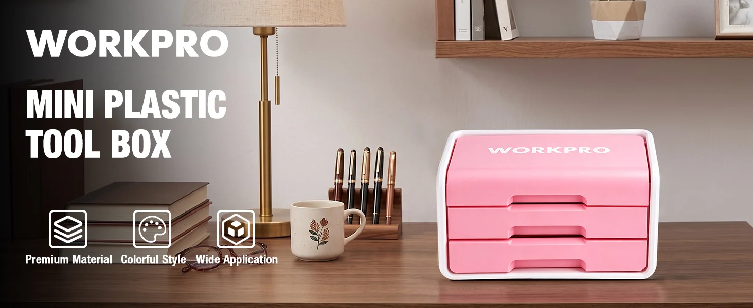 Pink mini plastic tool box with WORKPRO label on a desk, beside pens, books, and a lamp