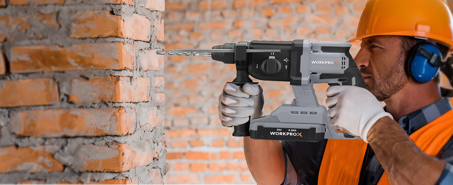 Construction worker wearing a helmet and gloves using a power drill on a brick wall, innovation and quality